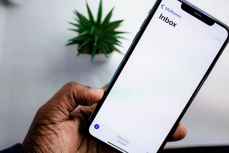 Person checking their email inbox on a smartphone