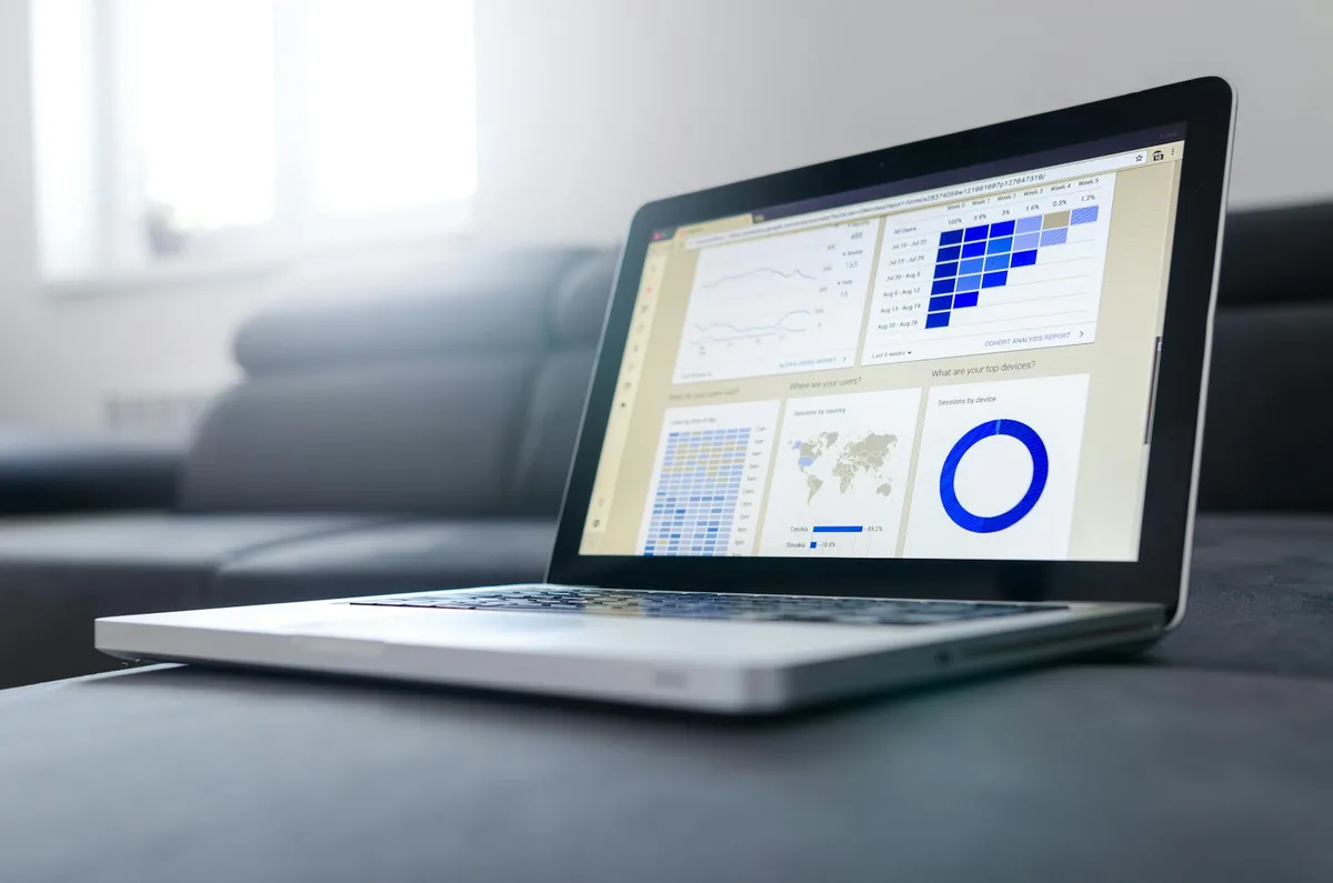 Malaysian ecommerce seller reviewing an SEO audit report on a laptop displaying Google Search Console organic traffic data