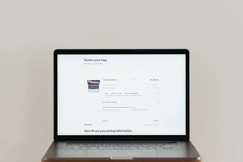 Laptop screen showing an online store’s cart review page with a product line item, price, and checkout button